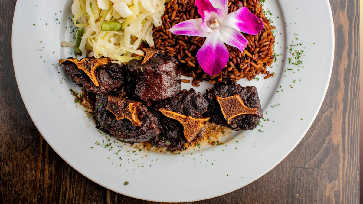 Jamaican Beef Oxtail, served with rice and cabbage. Image Credit: RFondren Photography/ Shutterstock