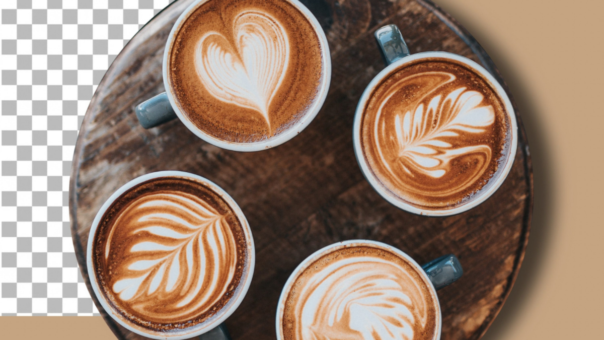 perfectly crafted cups of latte art sit invitingly on a rustic wooden table, each showcasing intricate designs. Image Credit: timorlorosae/123RF