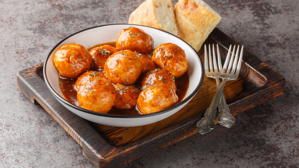 Spicy and sweet, chipotle honey glazed meatballs closeup on the bowl on the table