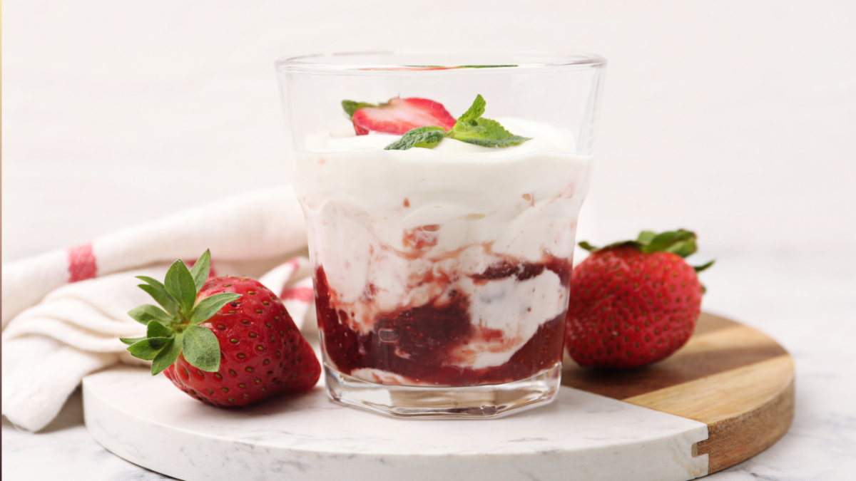 Tasty yogurt with strawberries, mint and jam in glass