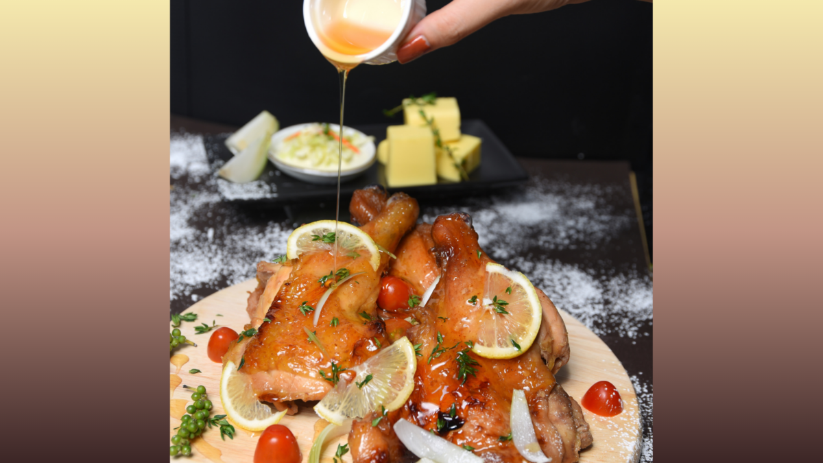 A woman's hands drizzling honey on grilled chicken wings.
