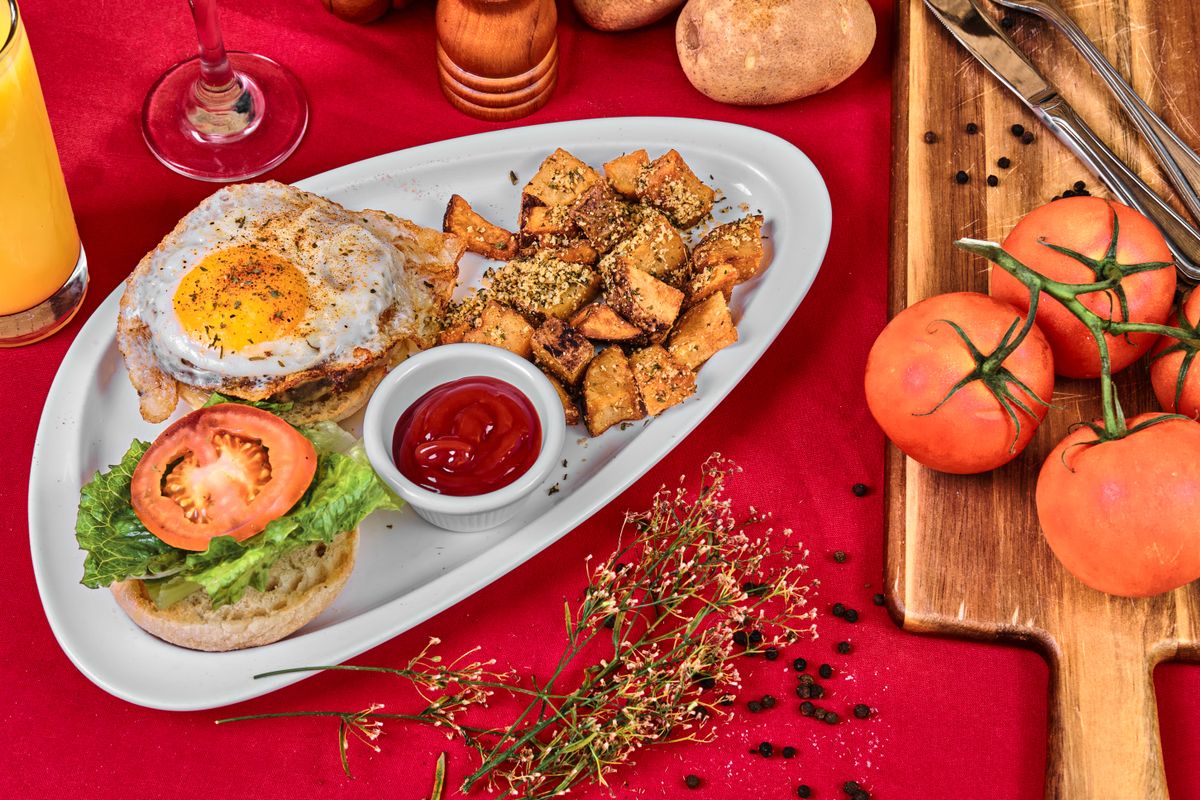 These 7-Ingredient Breakfast Potatoes Deliver the Crispy, Golden Morning You Deserve 1 A delicious gourmet burger topped with fried egg and a side of seasoned home fries.