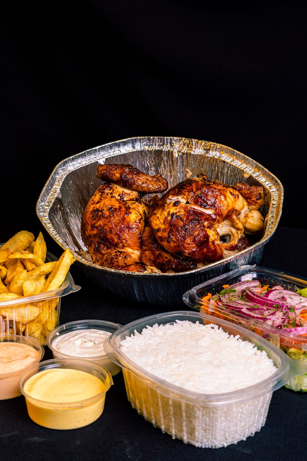 One Rotisserie Chicken, 10 Totally Different Dinners: Your Weeknight Shortcut Just Got Delicious 2 A mouthwatering rotisserie chicken served with rice, fries, and fresh salad, perfect for a hearty meal.