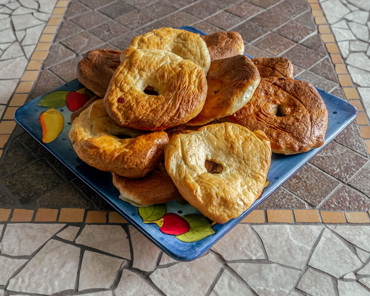 4 Iconic Spots In New York Where Locals Go for the Real Deal Of Bagels 1 A plate of freshly baked homemade bagels on a decorative plate, ideal for breakfast ideas.