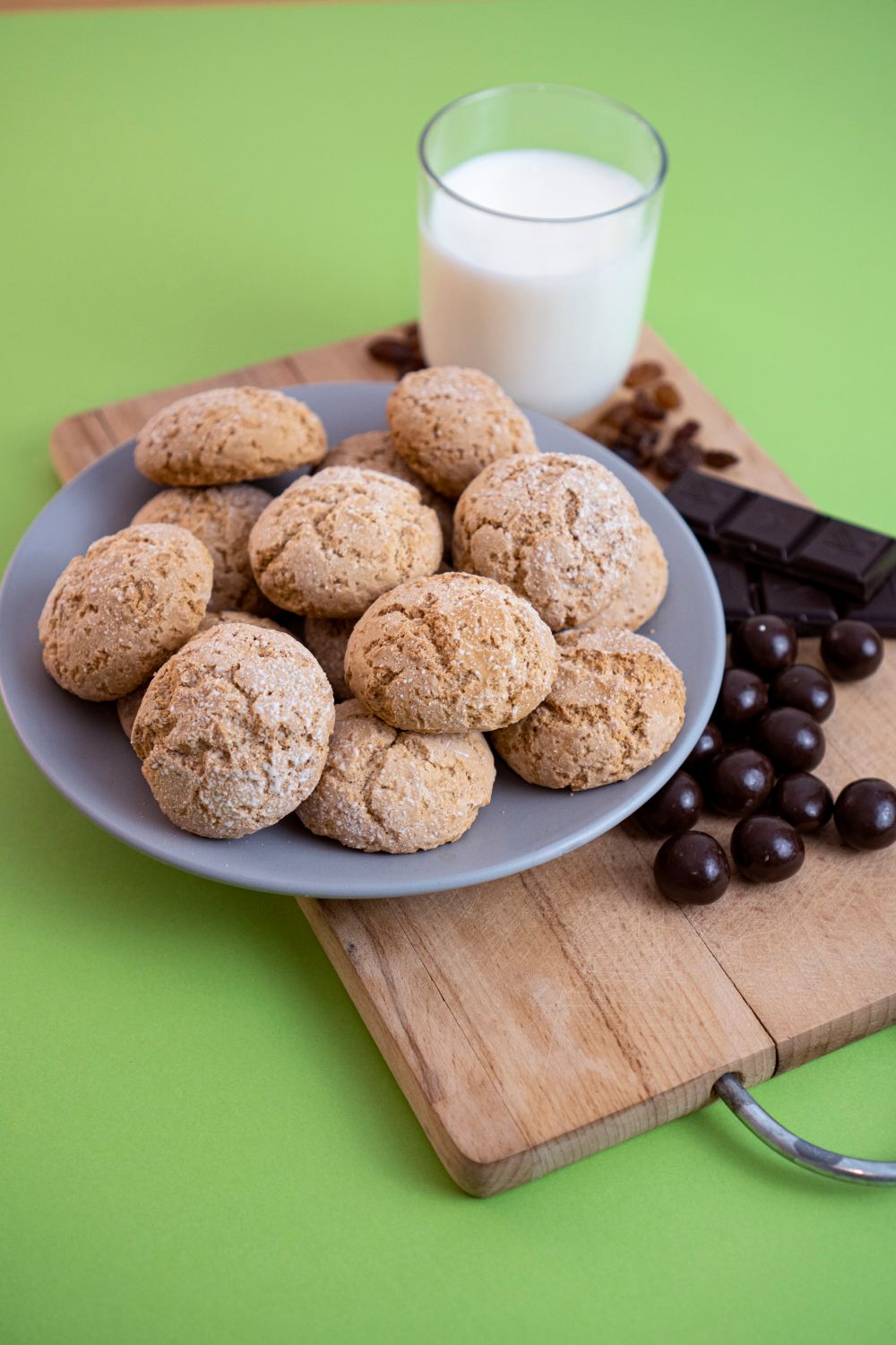 A tempting display of homemade cookies, chocolate, and milk on a wooden board.