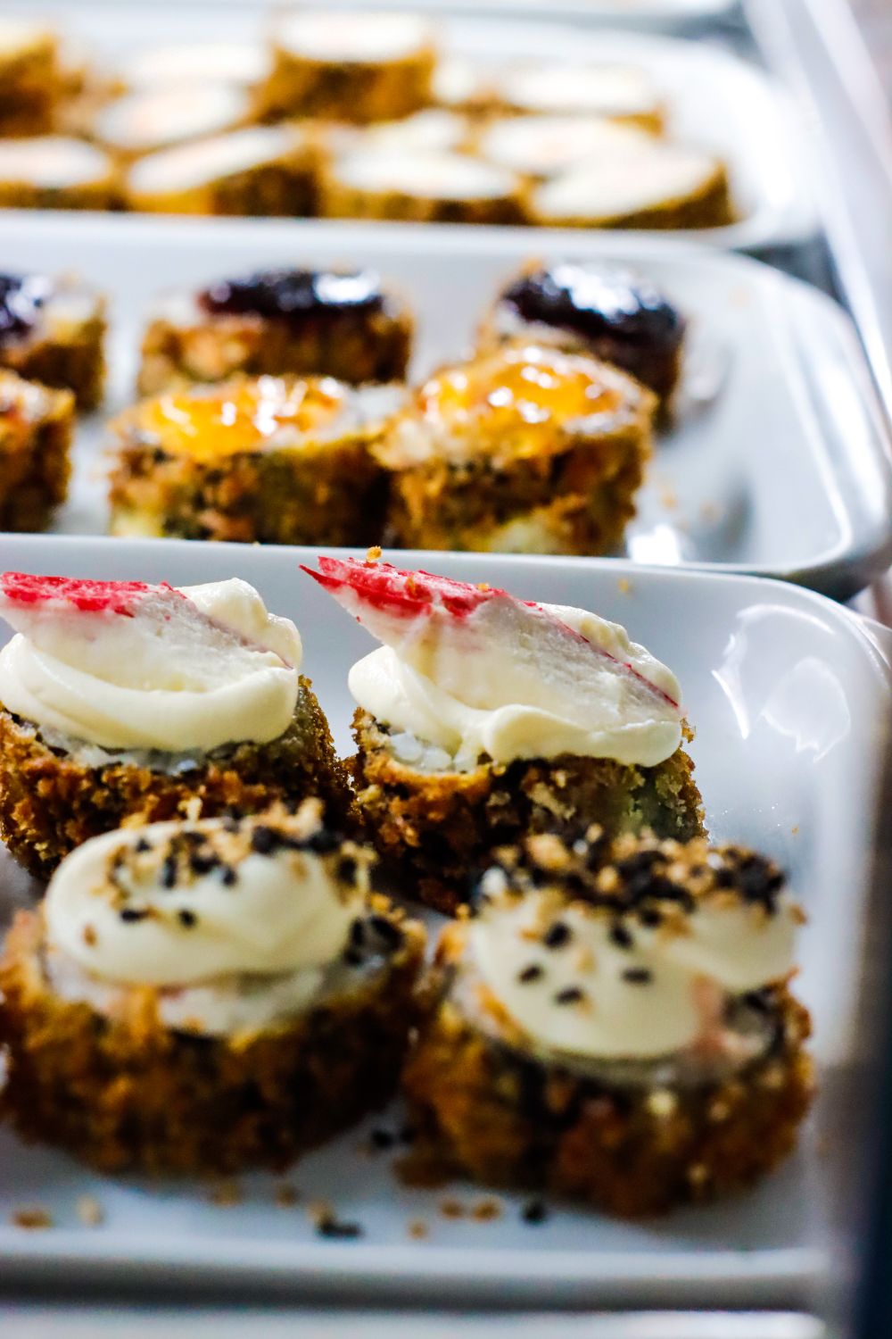The Big E’s 2026 Menu Adds Sushi Pops, Korean Corn Dogs, And More Than 100 New Fair Food Creations 2 Appetizing close-up of assorted sushi rolls with creamy toppings on a white plate.