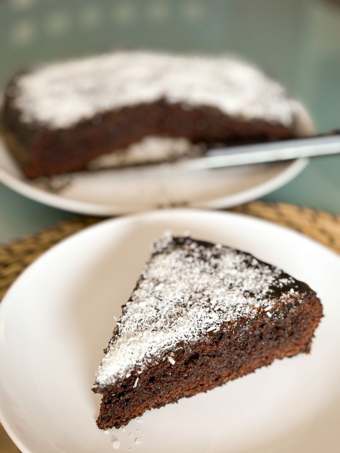 Close-up of a chocolate cake slice topped with powdered sugar, enticing dessert choice.