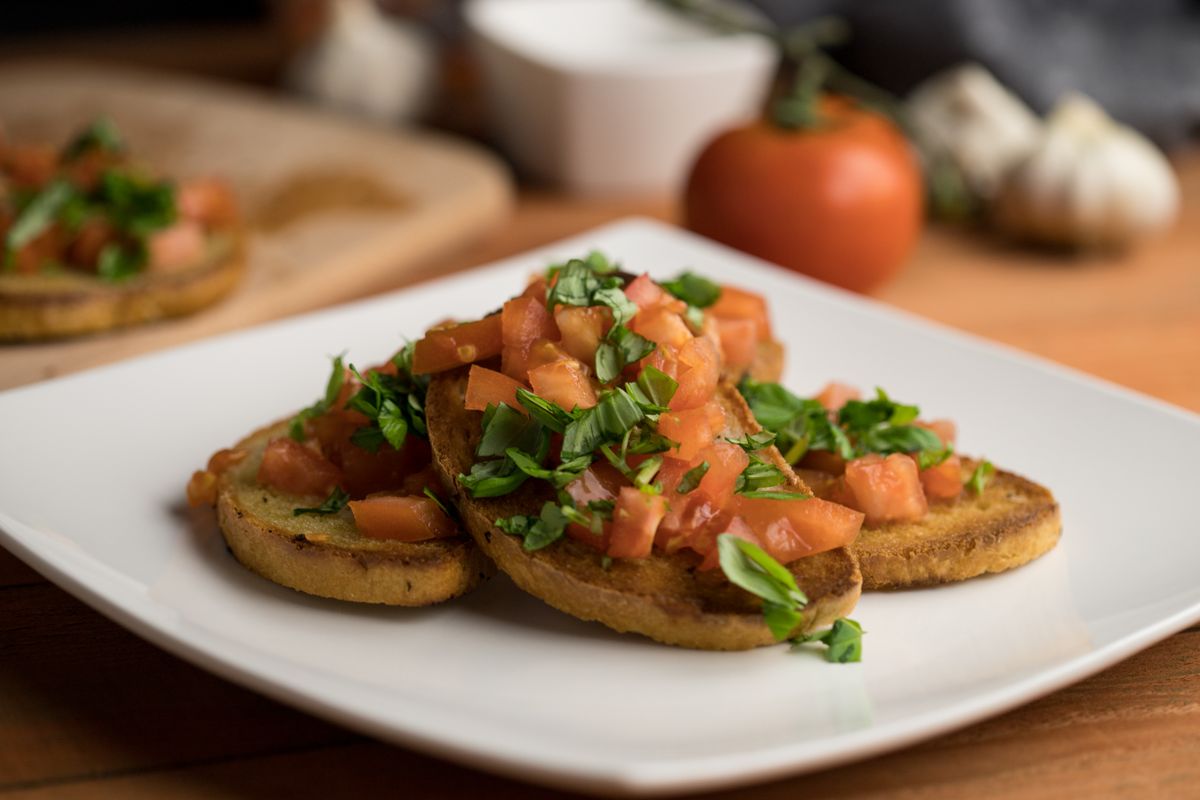 Close-up of flavorful Italian bruschetta topped with fresh tomatoes and herbs.