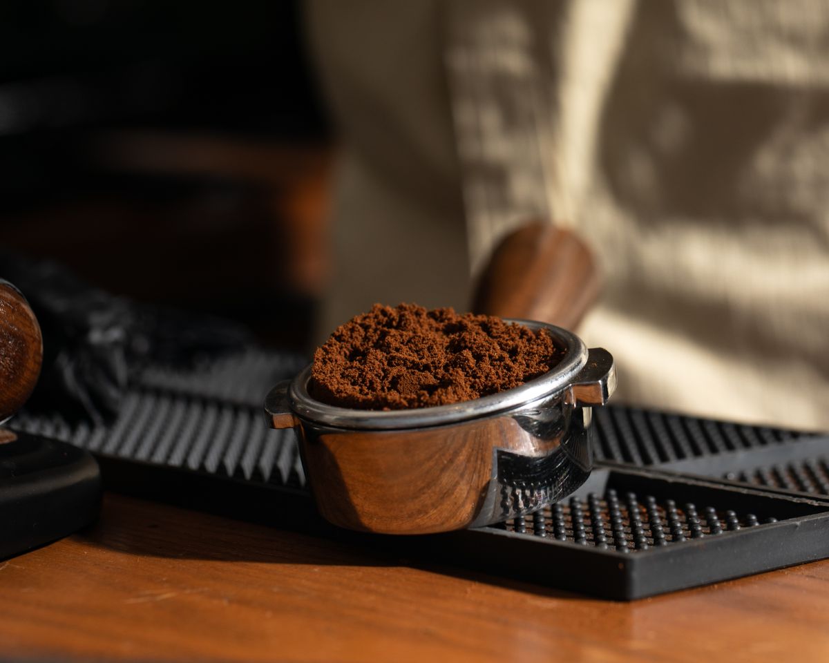 Close-up of freshly ground coffee in a portafilter, ready for brewing espresso.