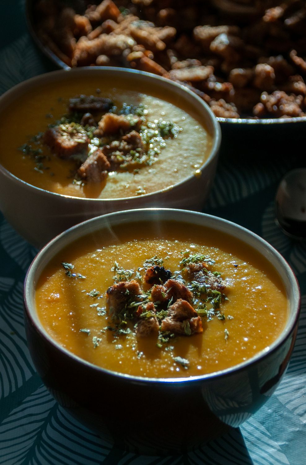 Delicious pumpkin soup served in bowls with croutons, perfect for a cozy autumn meal.