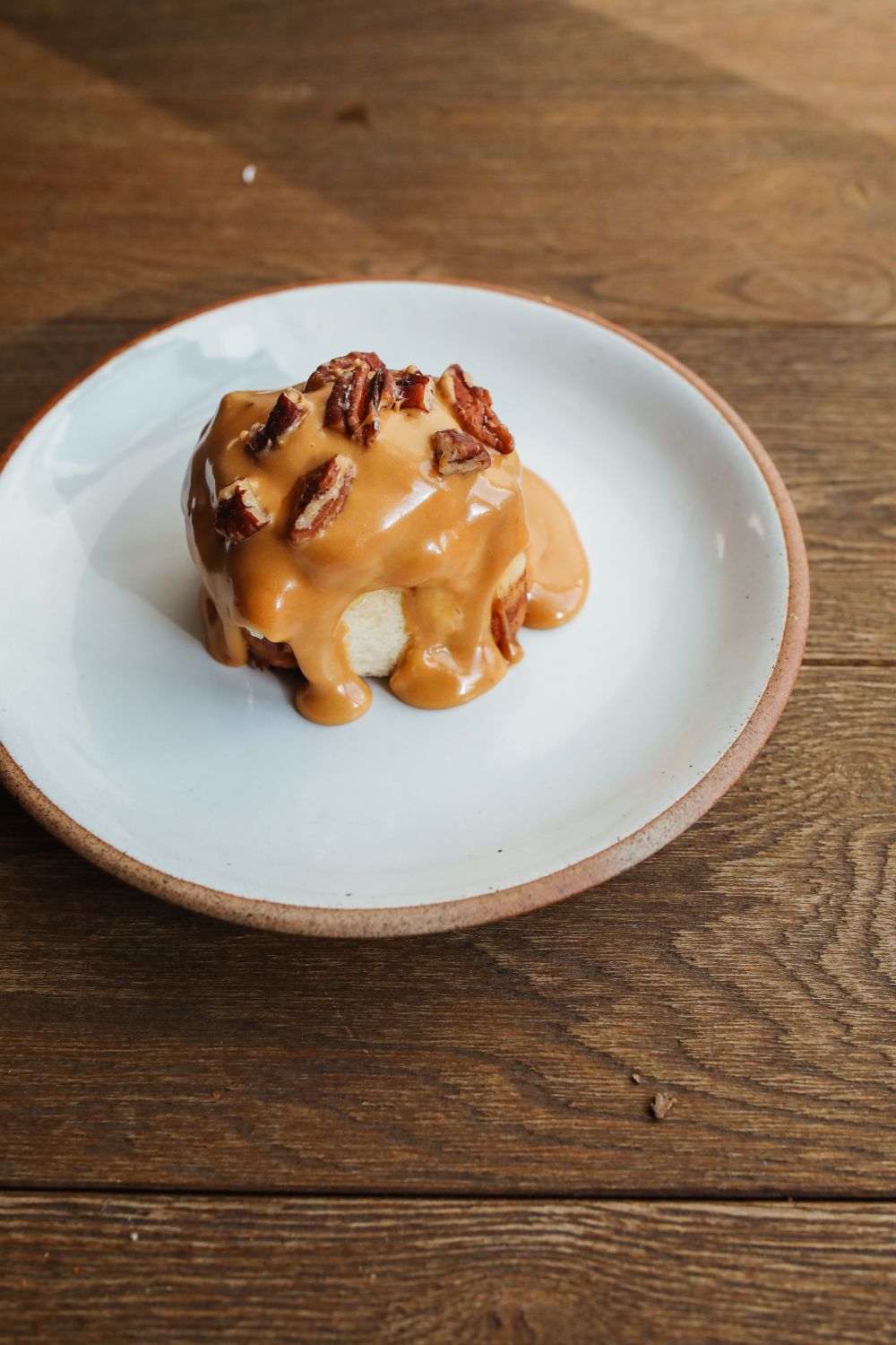 Five Traditional English Desserts You Must Try At Least Once in Your Life. 1 Delicious sticky toffee pudding topped with pecans, served on a rustic wooden table.