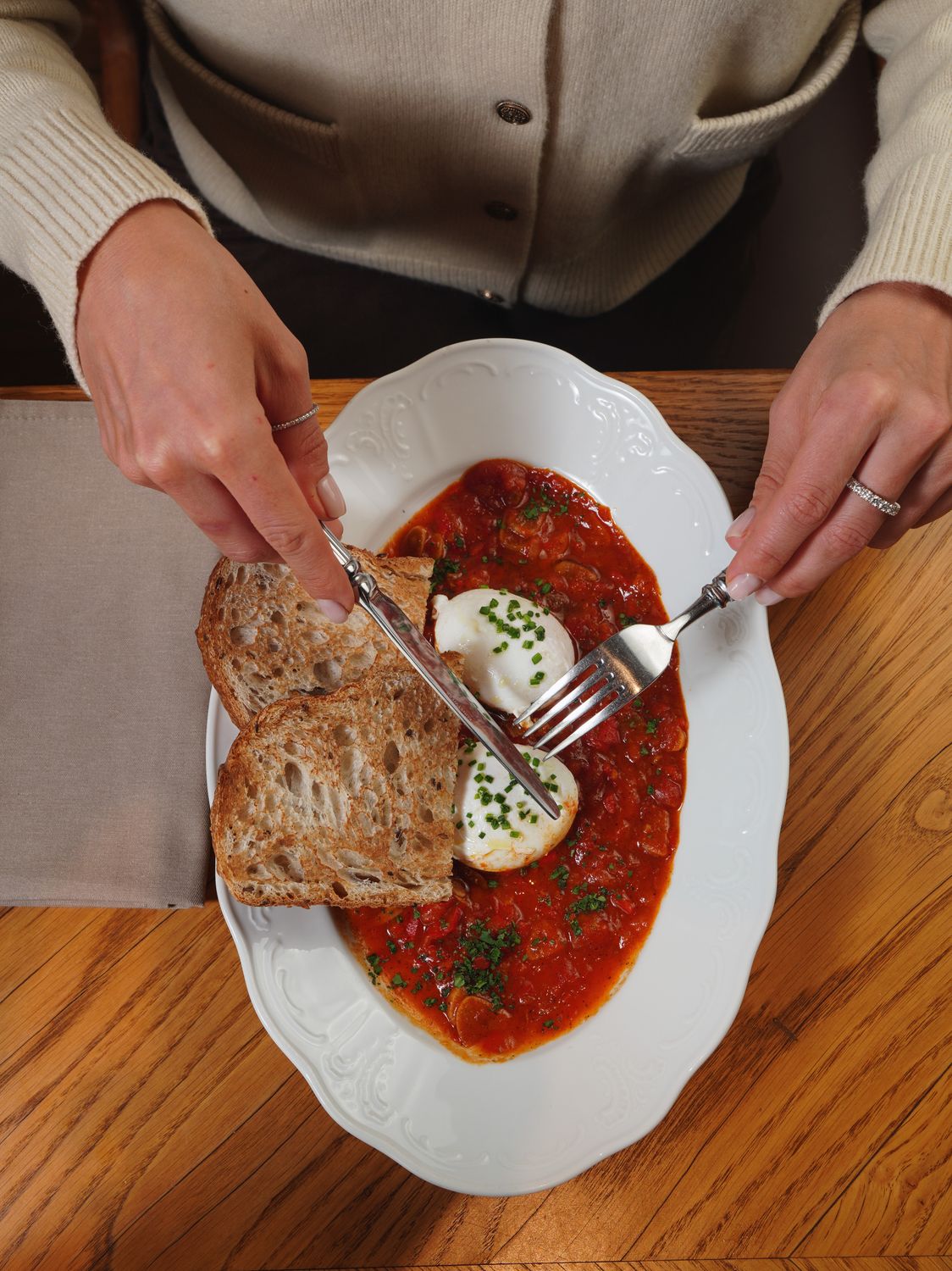 9 Fast Dinners That Taste Like You Spent All Day Making Them 2 Elegant presentation of shakshuka topped with poached eggs and served with rustic bread.