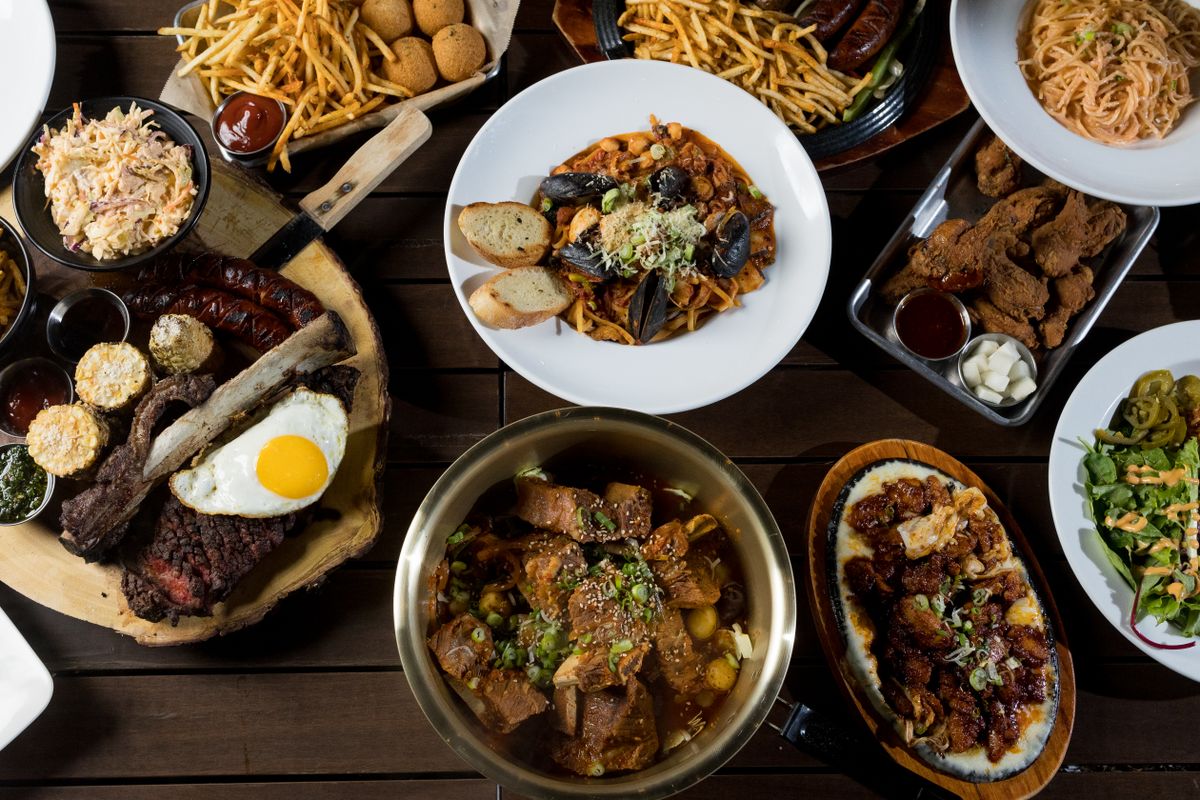The 9 Restaurant Dishes Food Editors Can’t Stop Thinking About Right Now 1 High angle view of a delectable gourmet spread featuring assorted international dishes.
