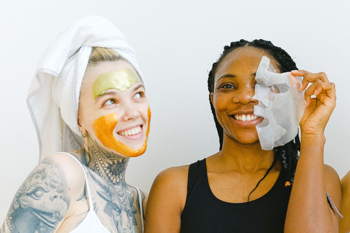 8 Surprising Uses For Coffee Beyond Your Morning Cup. 1 Two women sharing a joyful moment during their skincare ritual with facial masks.