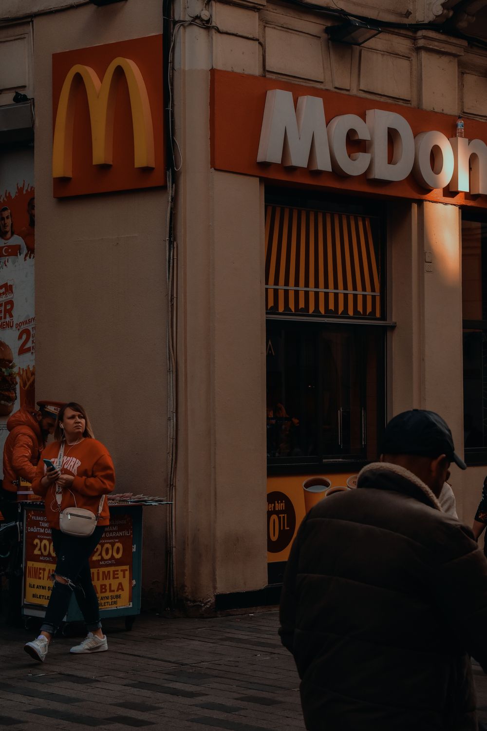 Urban scene featuring McDonald's storefront on a busy Istanbul street with pedestrians.