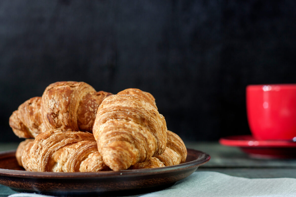 7 Grocery Store Bakery Items That Are Actually Worth Buying 2 Fresh, tasty croissants with a cup of fragrant coffee