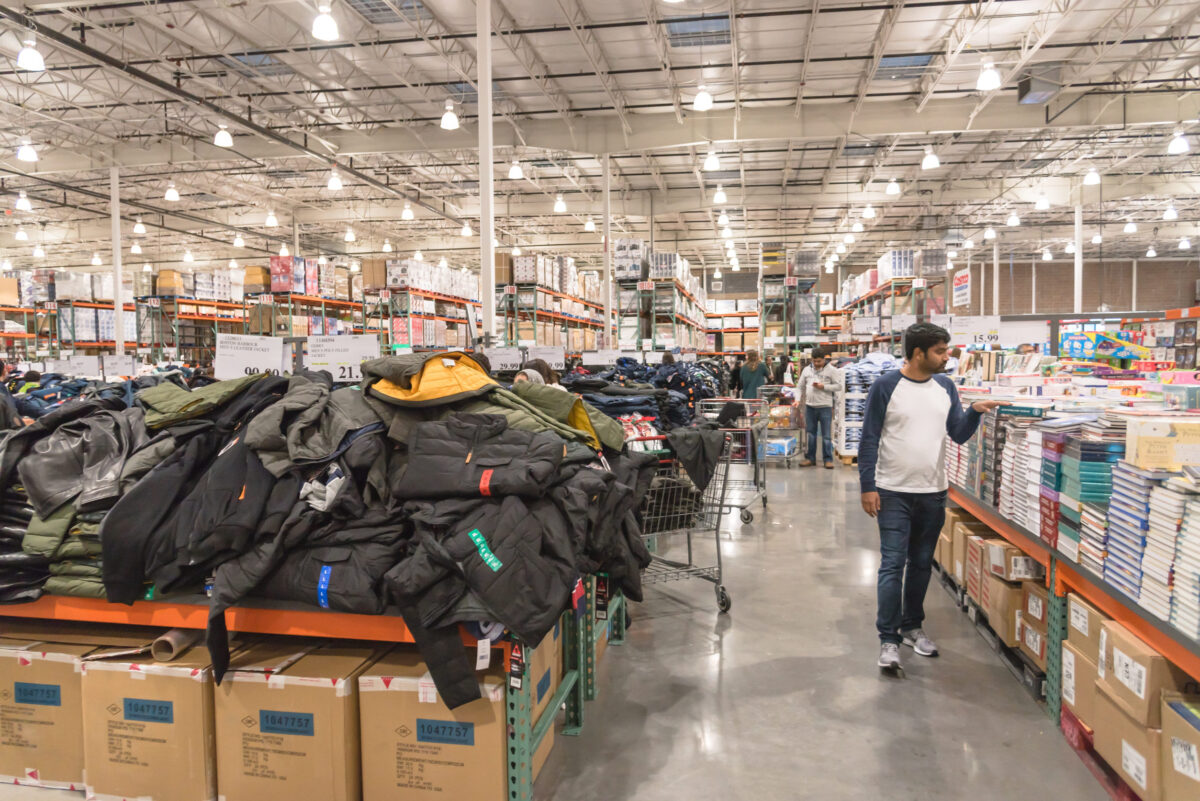 LEWISVILLE, TEXAS, USA-NOV 29, 2019: Clothes department with diverse customer browsing clothing products on sale on Black Friday at Costco Wholesale.