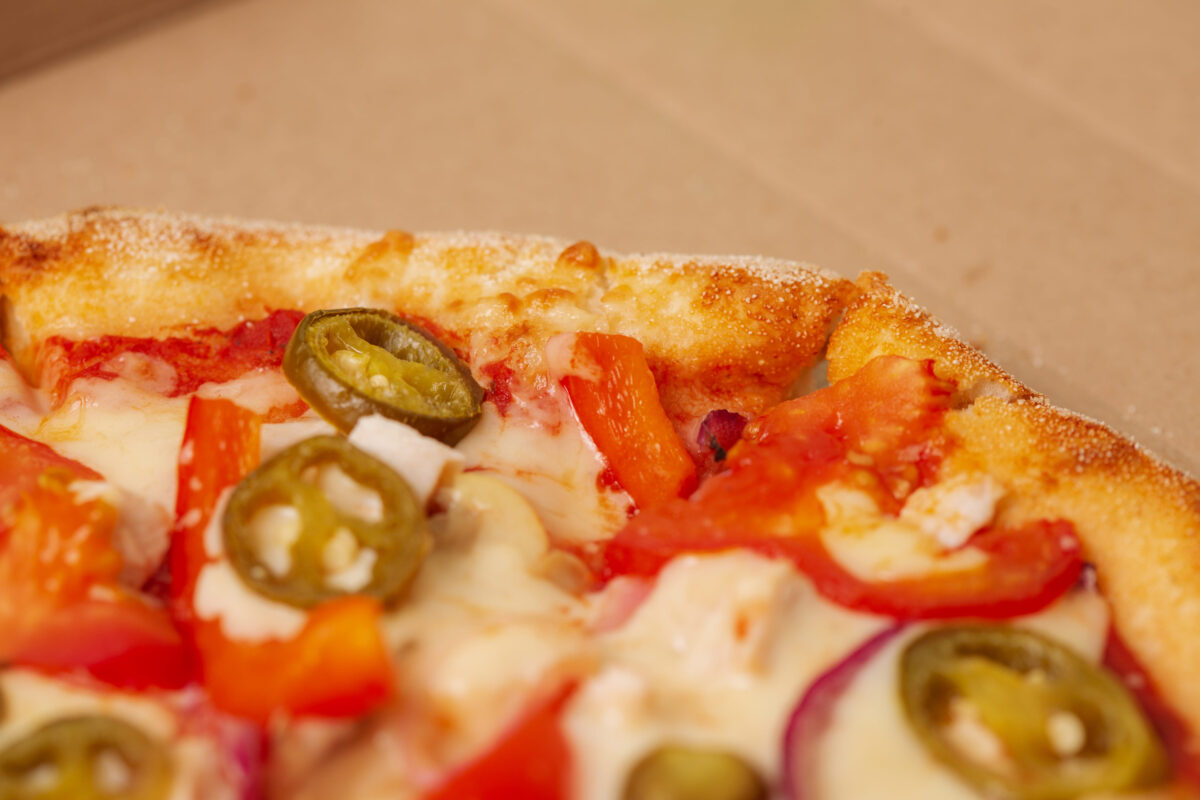 Pizza in cardboard delivery box. Fast food concept. Food background texture. copy space
