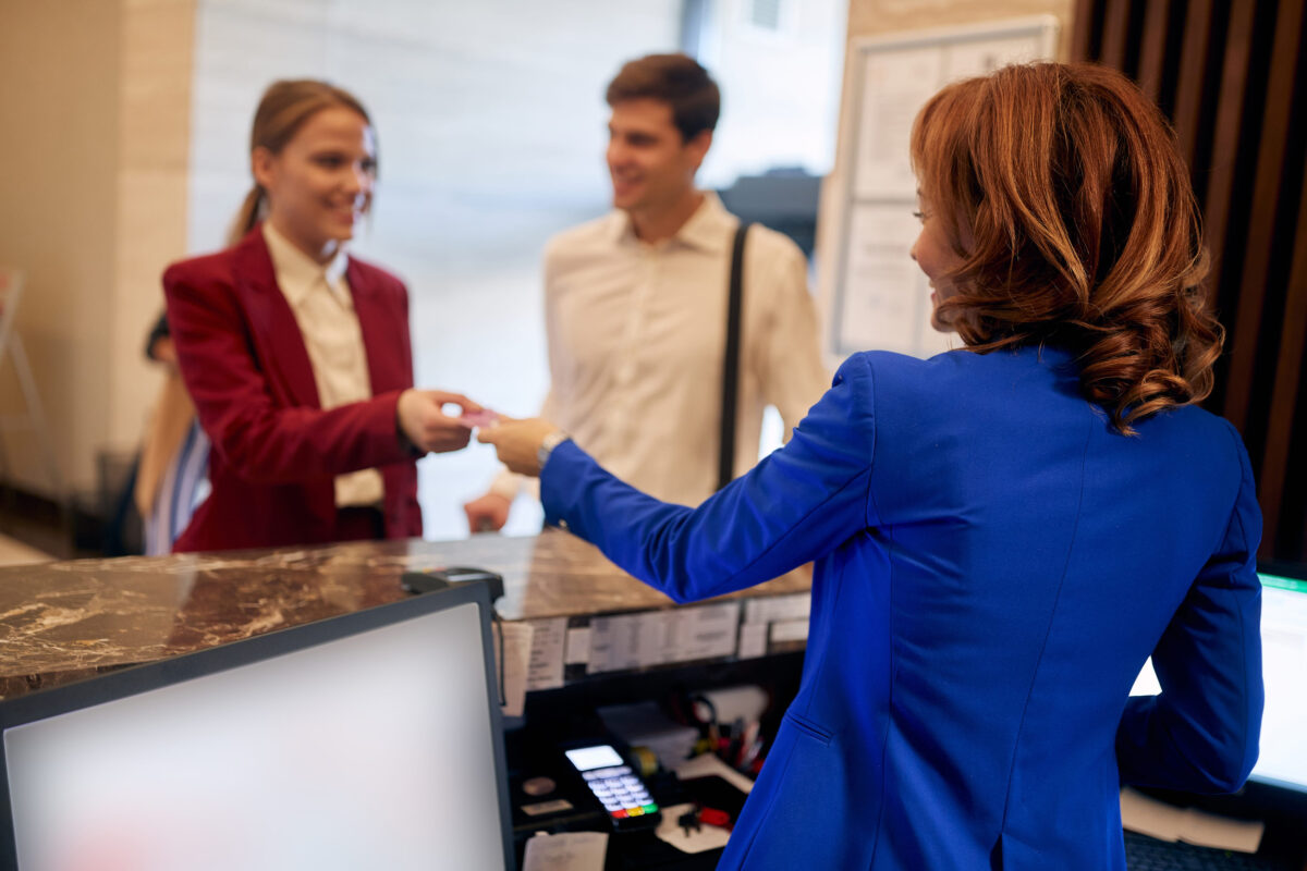 Young caucasian business couple checking in at hotel reception