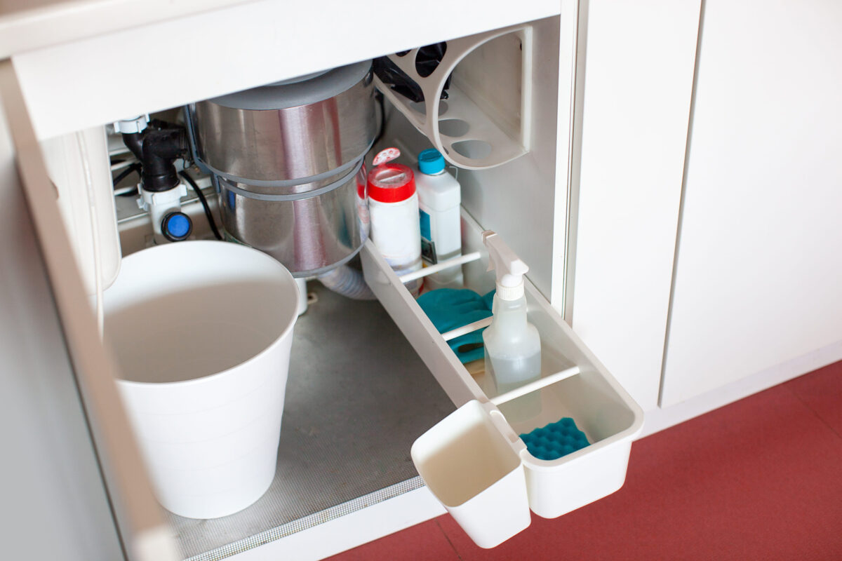 Modern kitchen organization. Drawer under the sink. Convenient storage. Food waste disposer. Zero waste.