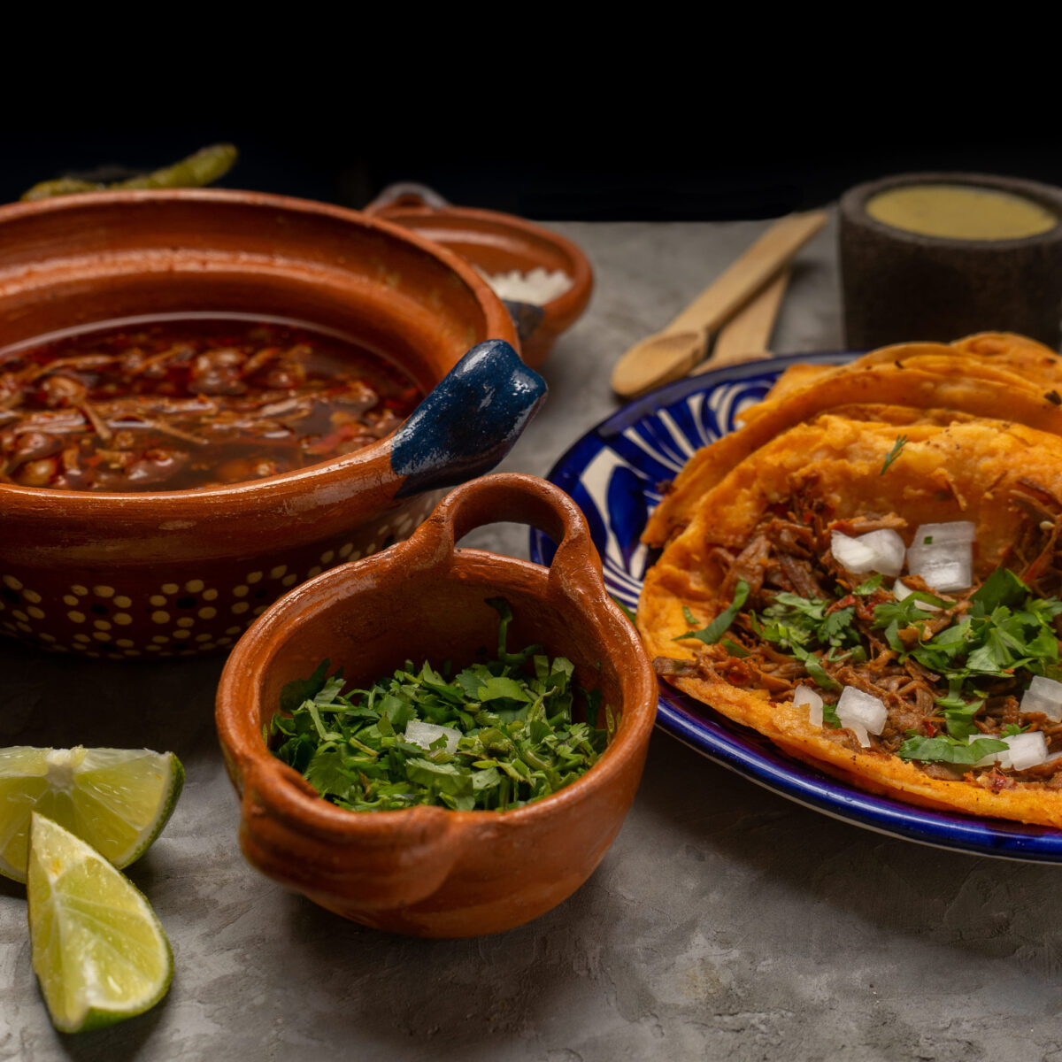 8 Foods Americans Love From Around the World 1 Birria tacos and broth on a gray background. Traditional mexican food