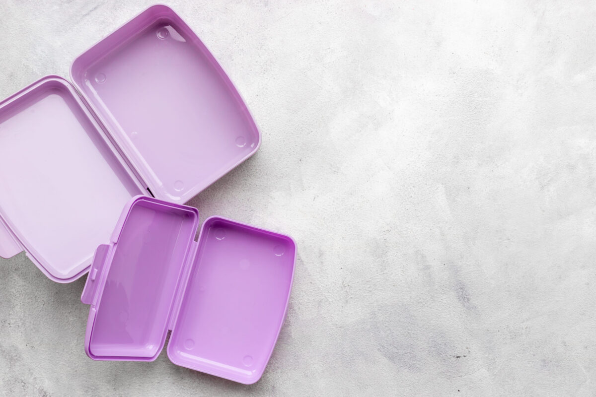 Empty purple lunch boxes, top view. Plastic container for food