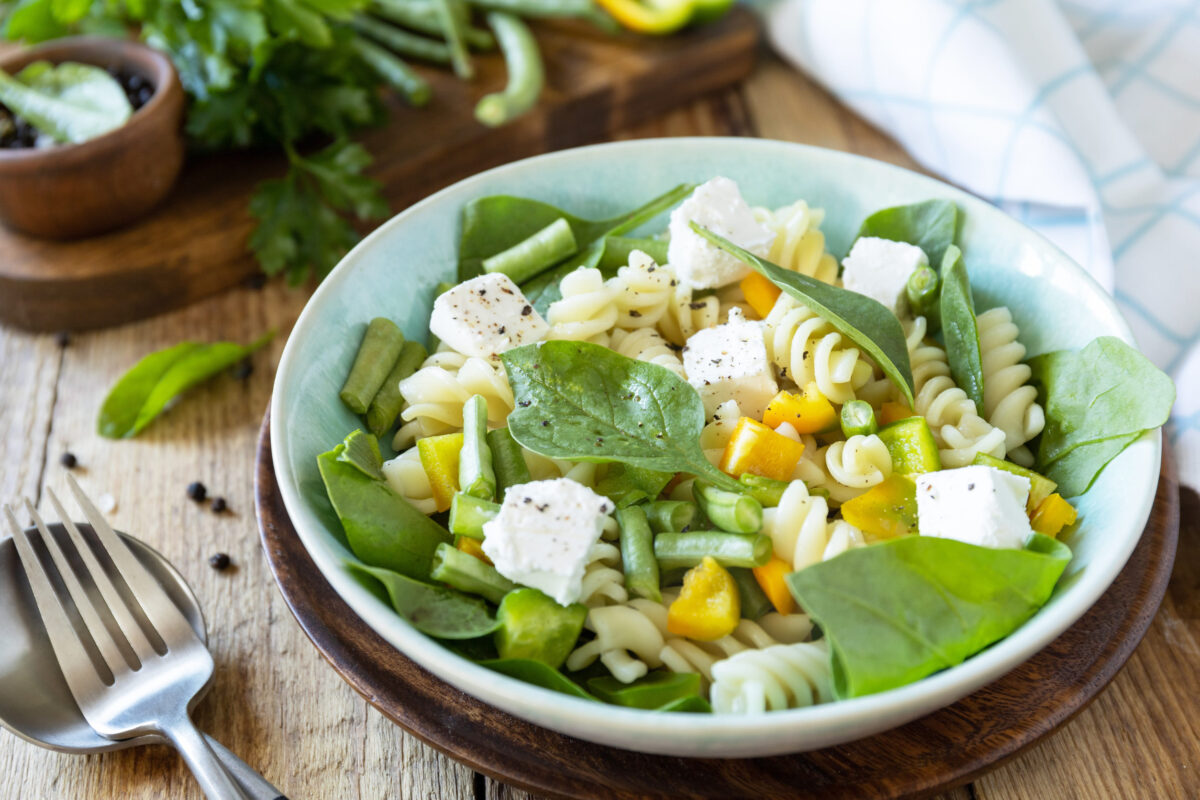 9 Lunchbox Ideas for Kids Who Are Tired of Sandwiches 1 Cold delicious pasta salad, italian cuisine. Whole wheat fusilli pasta with feta, green bean and pepper on a wooden background.