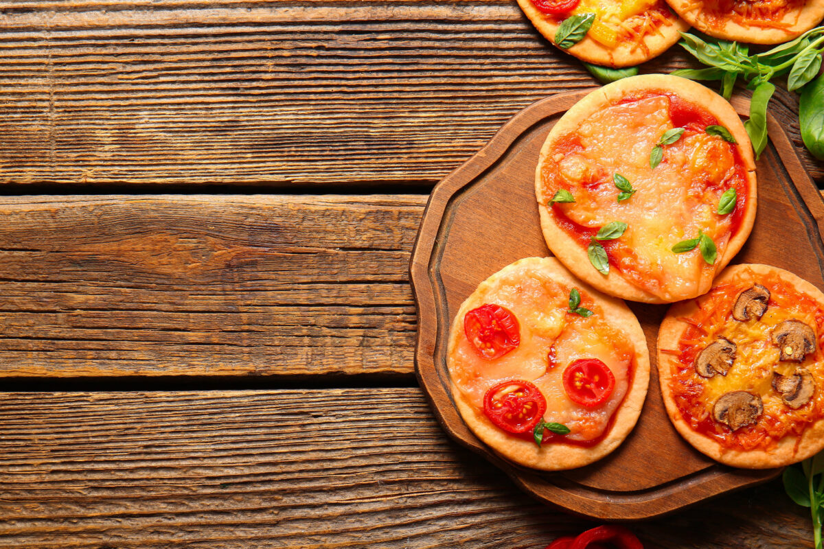 9 Lunchbox Ideas for Kids Who Are Tired of Sandwiches 3 Board with different tasty mini pizzas on wooden background