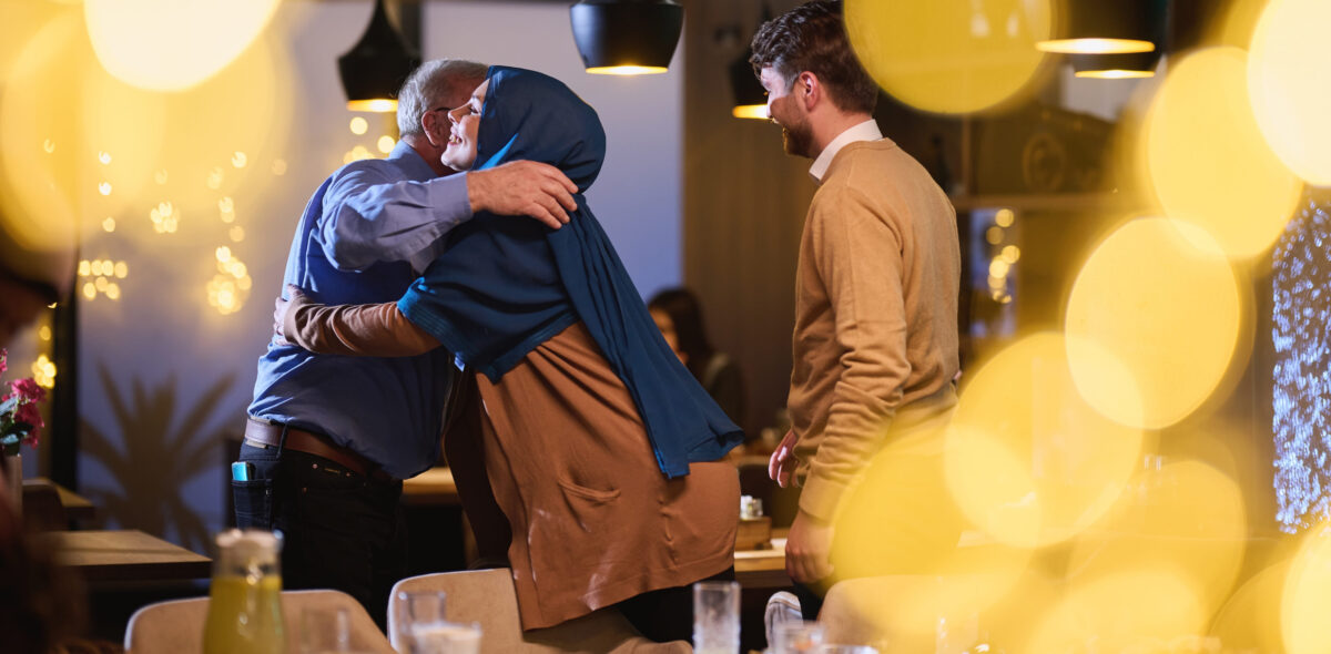 Grandparents arrive at their childrens and grandchildrens gathering for iftar in a restaurant during the holy month of Ramadan, bearing gifts and sharing cherished moments of love, unity, and cultural exchange, as they eagerly await their meal together