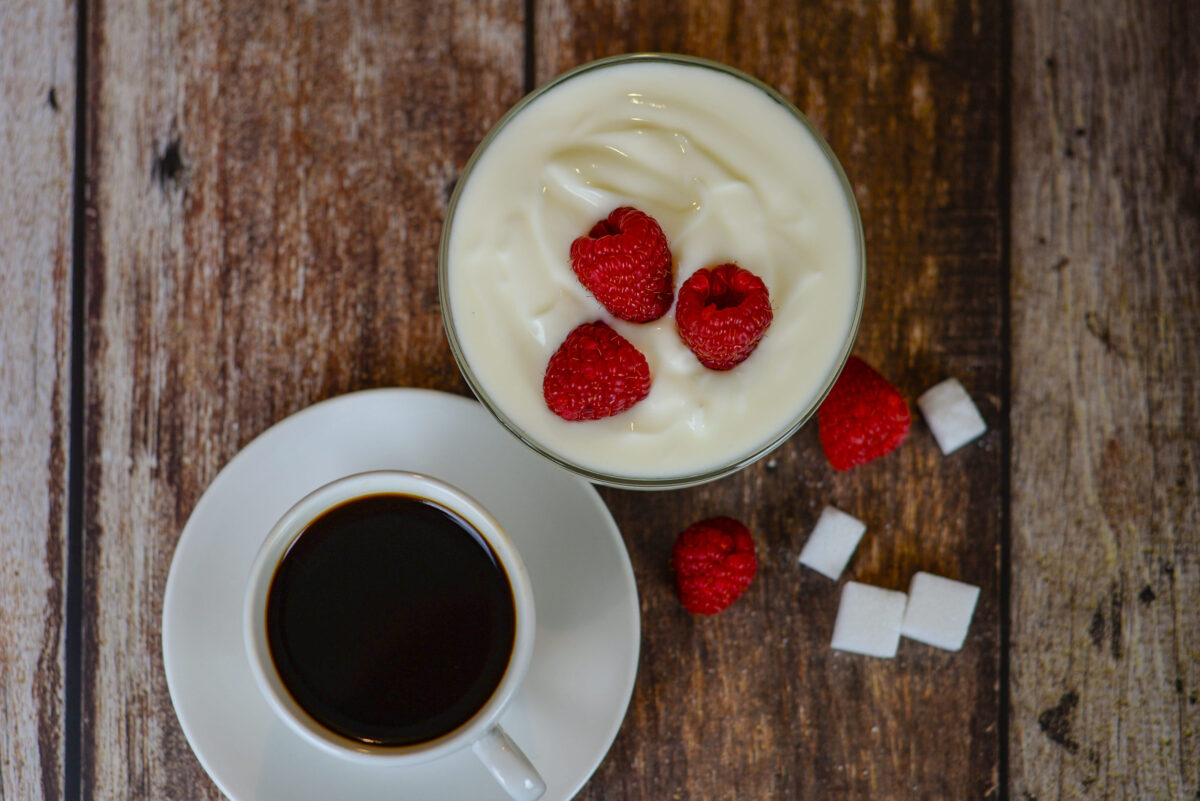 Greek yogurt with raspberries and coffee, healthy breakfast. High quality photo