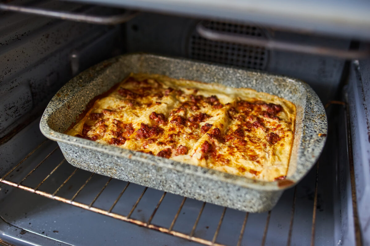 A delicious lasagna bakes to golden perfection in the oven.