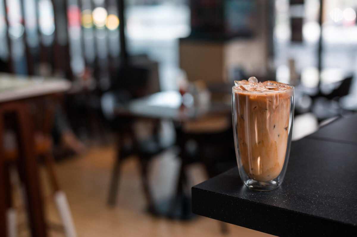 Close-up glass of iced coffee with milk on the table