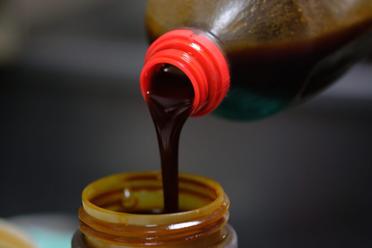 Pouring soy sauce into a bottle