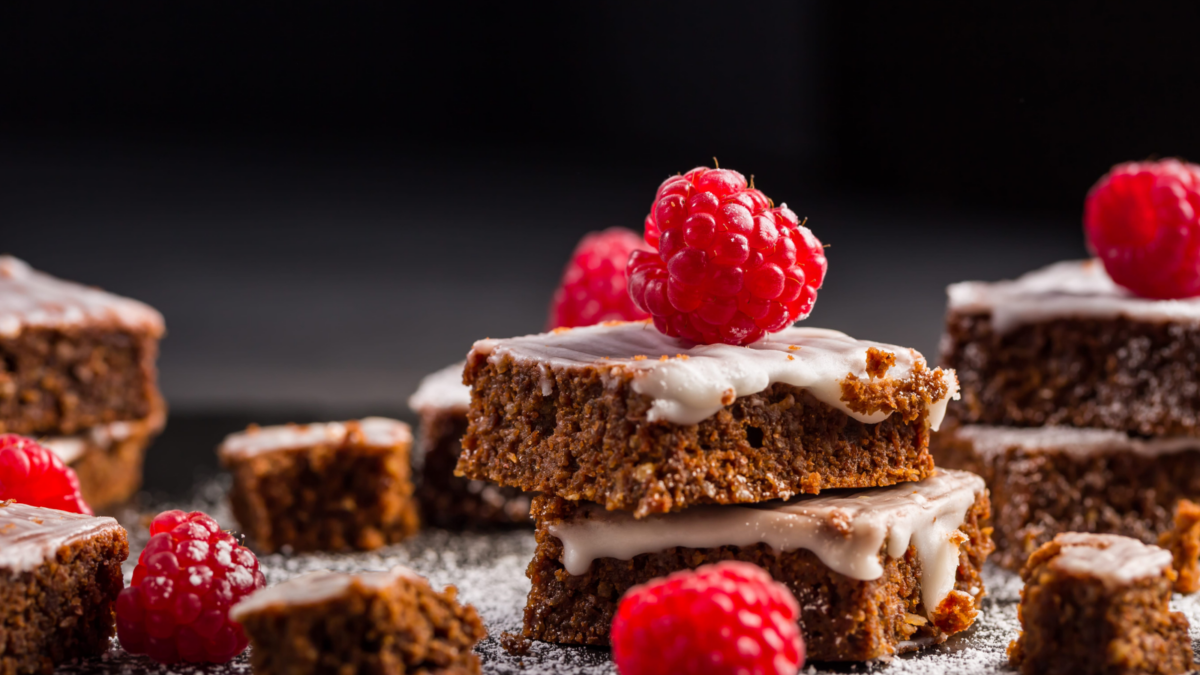 Brownies Taste Better With These Combos 1 Decadent chocolate brownies adorned with fresh raspberries, inviting a sweet escape. Each bite promises a rich, fudgy experience, perfectly complemented by a hint of creamy frosting. A dessert that captivates both the eyes and the palate. Image Credit: brebca/ 123RF