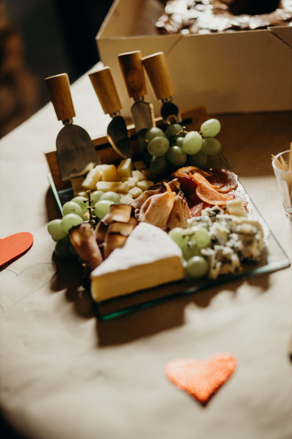 Why Roasting Grapes Can Turn an Ordinary Cheese Board Into Something Special 2 A delicious cheese and charcuterie platter featuring various cheeses, meats, and green grapes, perfect for Valentine's Day.