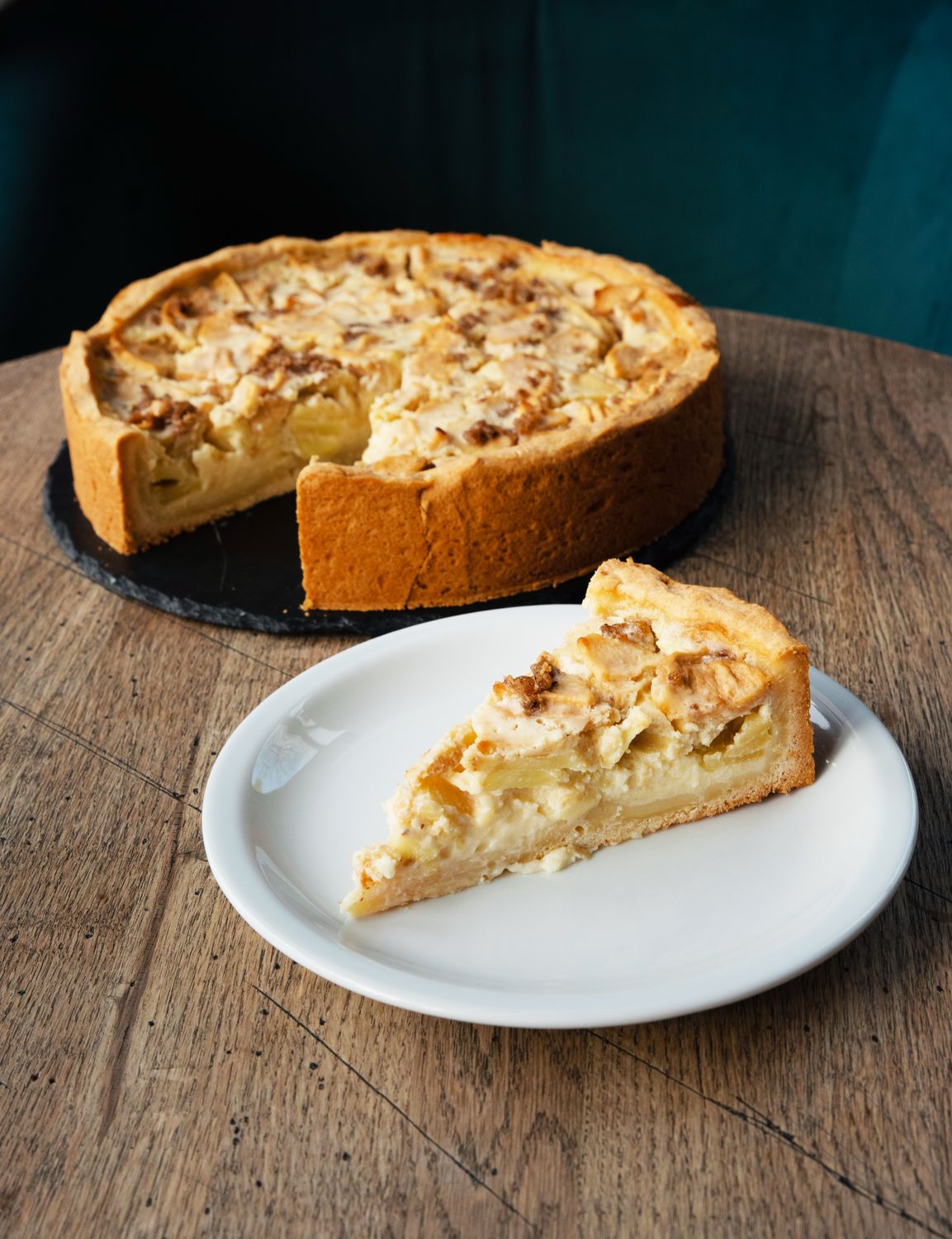 This French Onion Tart Delivers Golden Pastry and Melty Gruyère Without Making Dough From Scratch 1 A mouth-watering French apple tart with a slice served on a plate. Perfect for food enthusiasts.