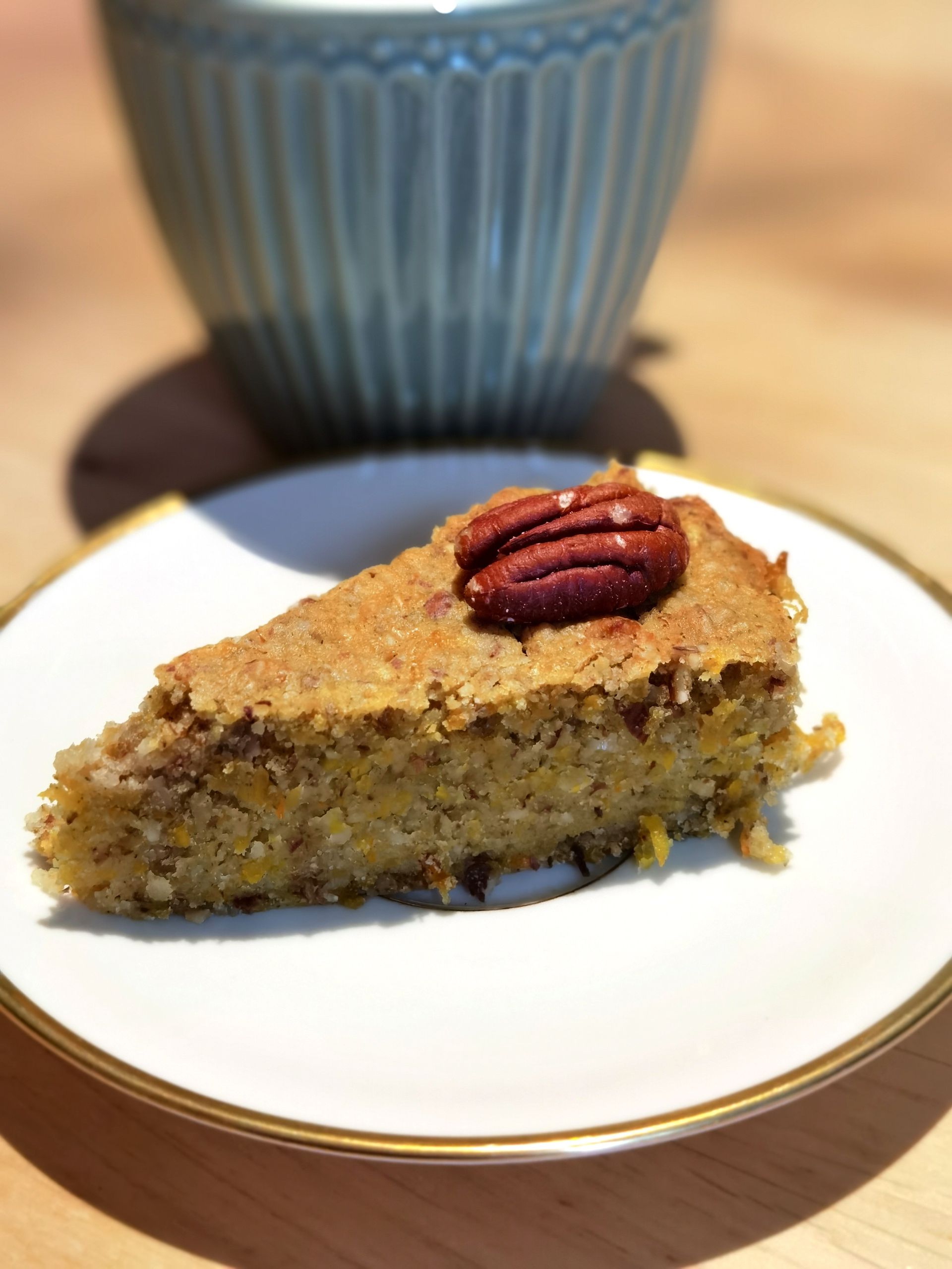 A slice of moist pecan cornbread cake on a plate, perfect for desserts.