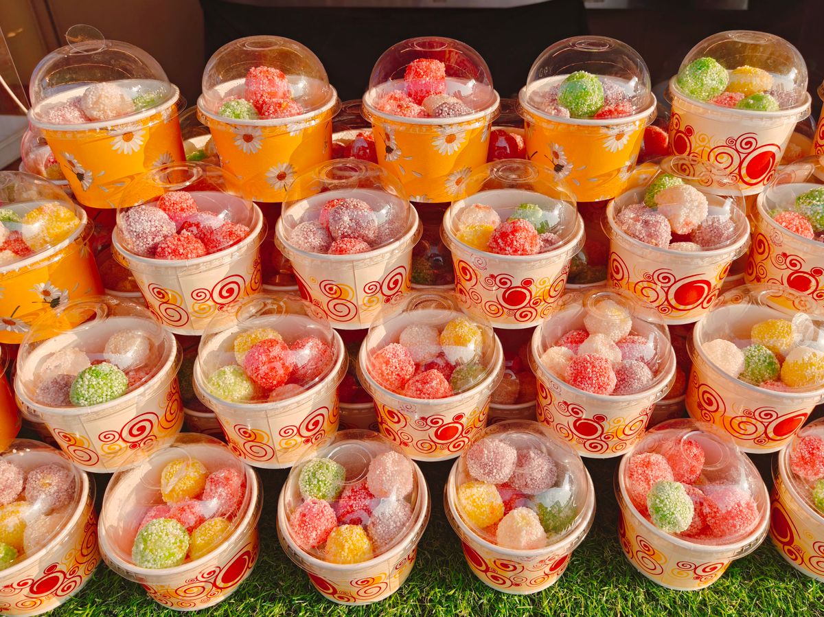 8 Candies Once Sold in America That Are Now Banned or Restricted 1 A vibrant array of sugar-coated jelly candies in decorative cups, displayed outdoors in Manila.