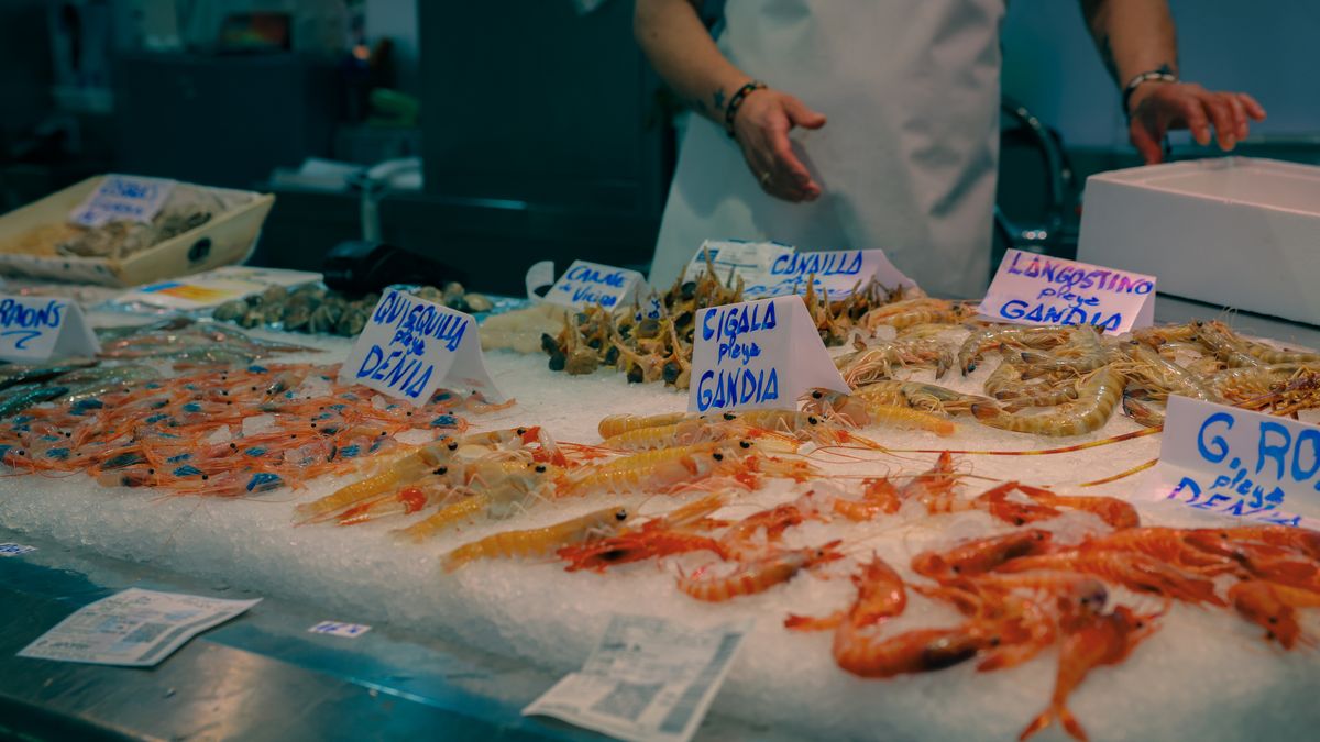 A vibrant seafood display at a market in Valencia, showcasing prawns, langoustines, and other shellfish.