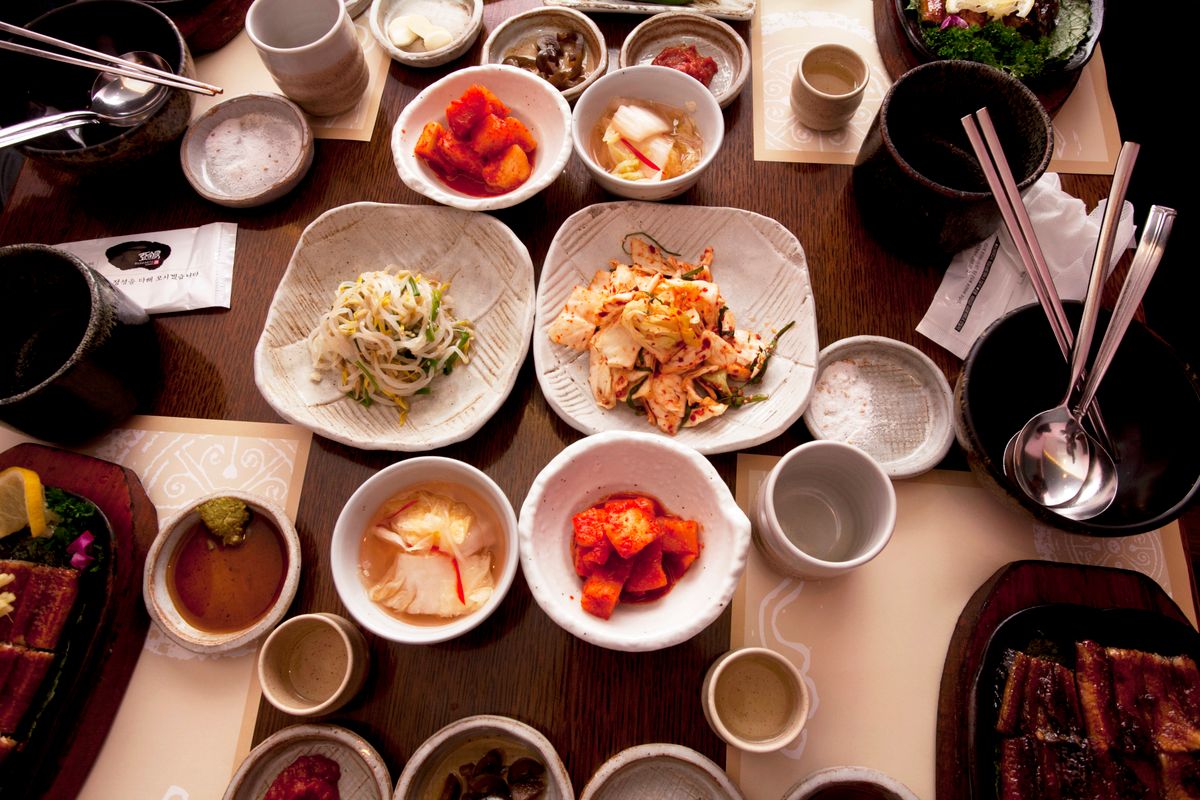 Those Little Dishes Aren’t Just Extras: What Makes a Korean Table So Special 1 An appetizing spread of traditional Korean dishes featuring kimchi and various side dishes, captured from above.