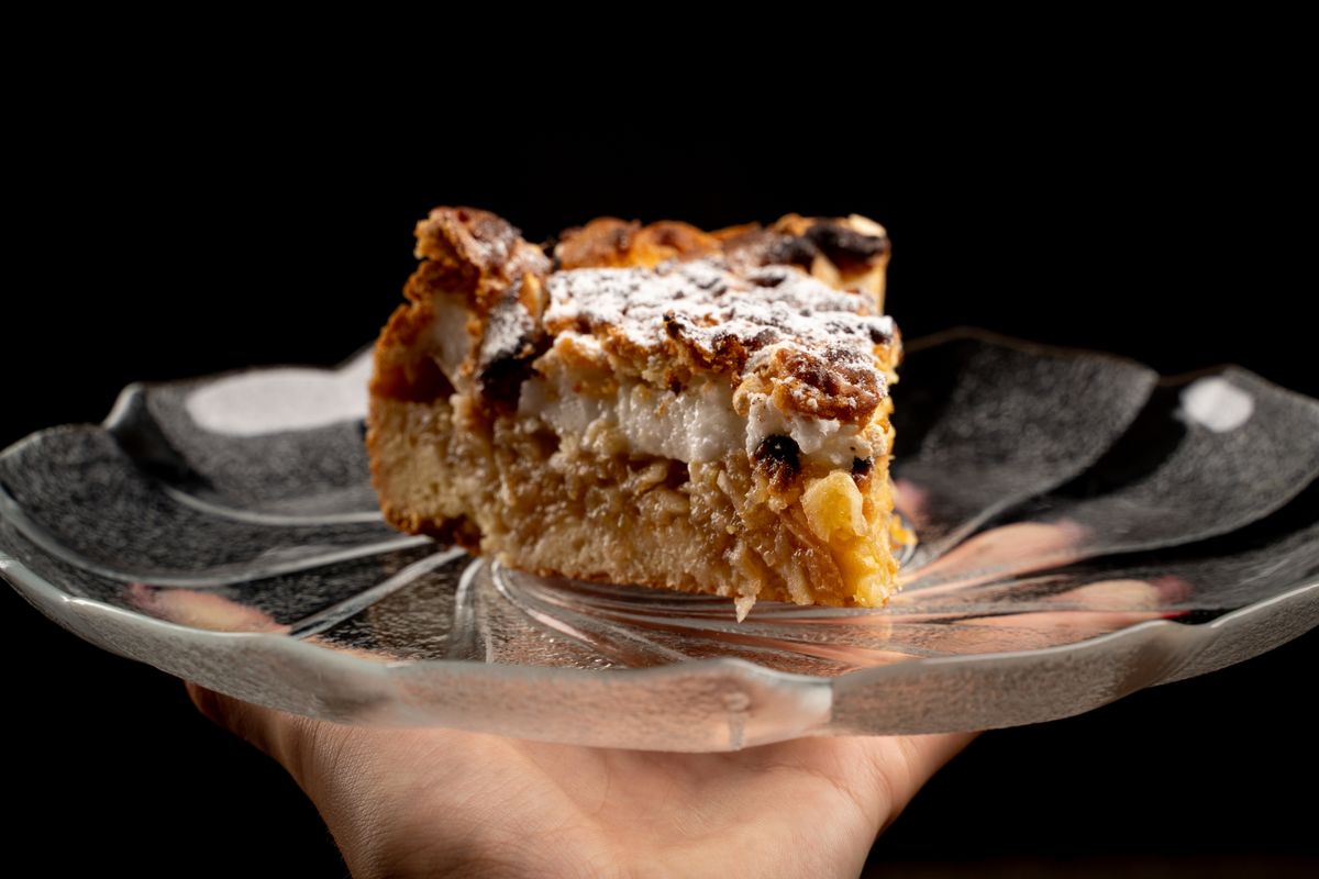 Close-up of a freshly baked apple cake slice on a glass plate, perfect dessert display.