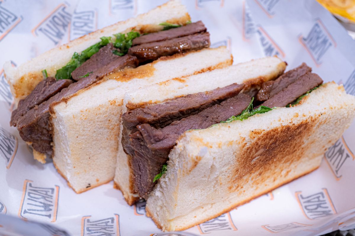 Close-up of a gourmet beef sandwich in toasted bread, perfect for lunch or brunch.