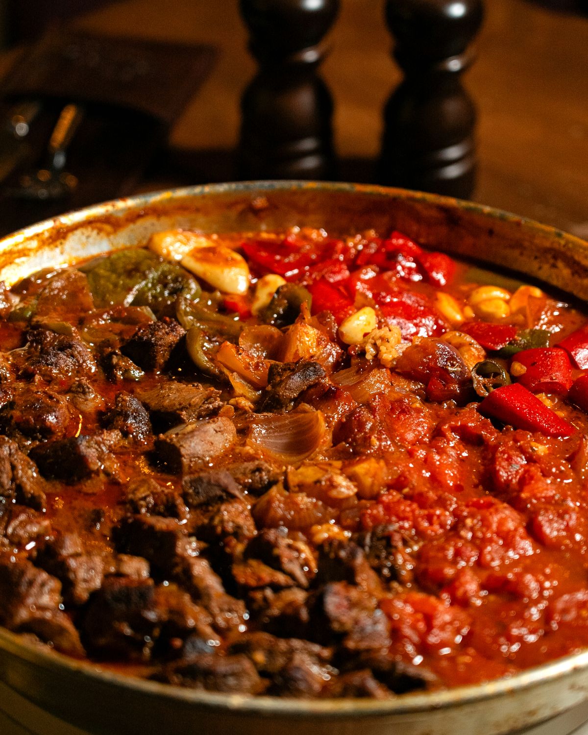 7 One-Pot Comfort Dinners That Make Weeknight Cooking Feel Easier 1 Close-up of a hearty beef stew with vibrant peppers and tomatoes, perfect for comfort food lovers.