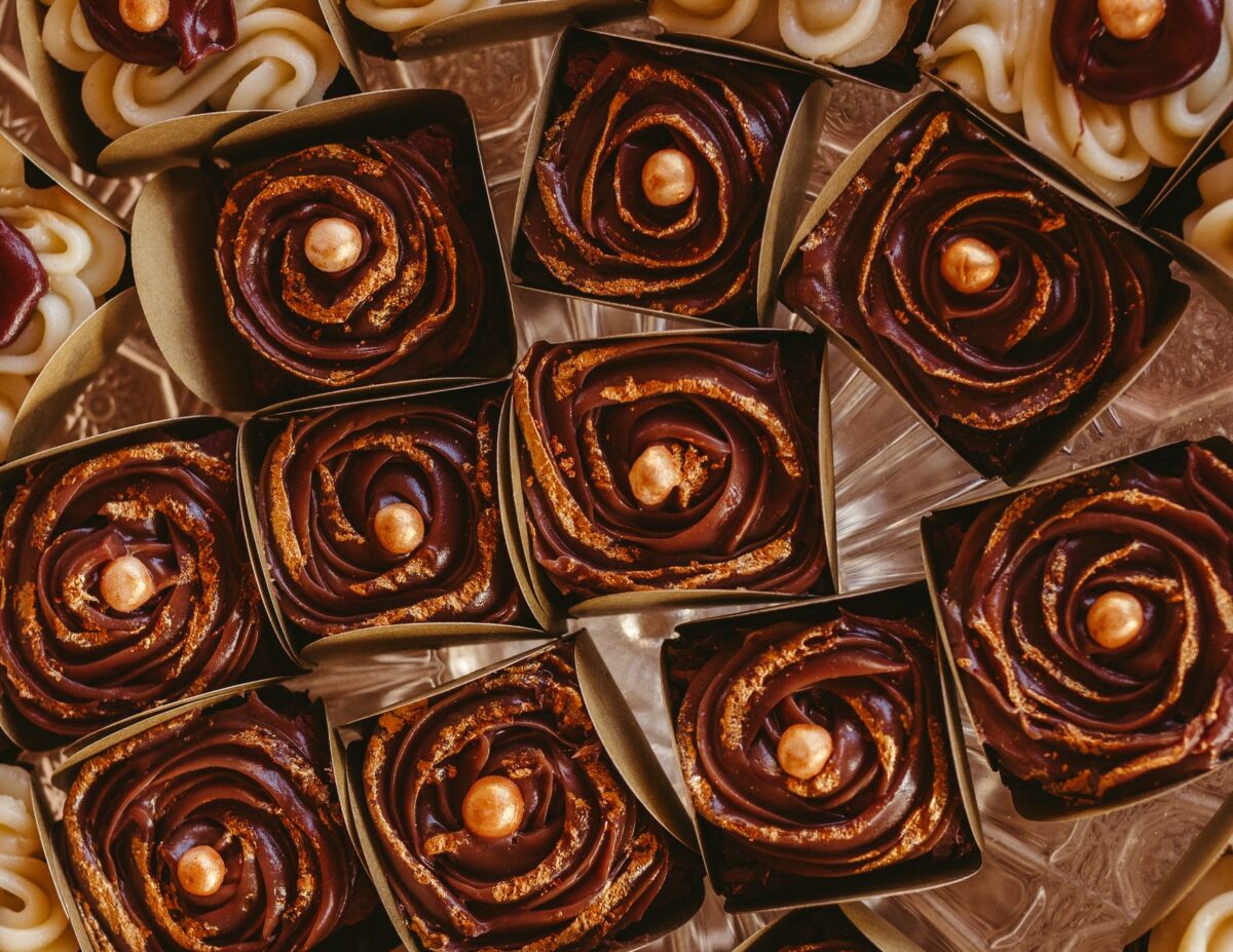 9 Things to Do with Leftover Halloween Candy 1 Close-up of assorted chocolate and cream cupcakes with elegant decorations, perfect for dessert lovers.