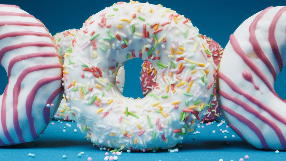8 Blood-Red Pitch-Black Halloween Foods and Drinks to Check Out This October 1 Close-up of colorful sprinkles and icing-decorated donuts on a vibrant background.