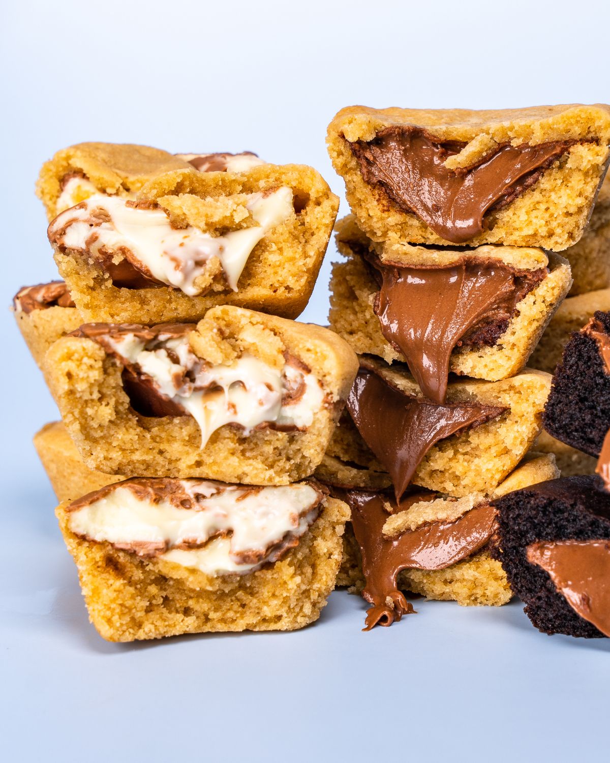 Close-up of stacked muffins filled with creamy Nutella and white chocolate, perfect for dessert lovers.