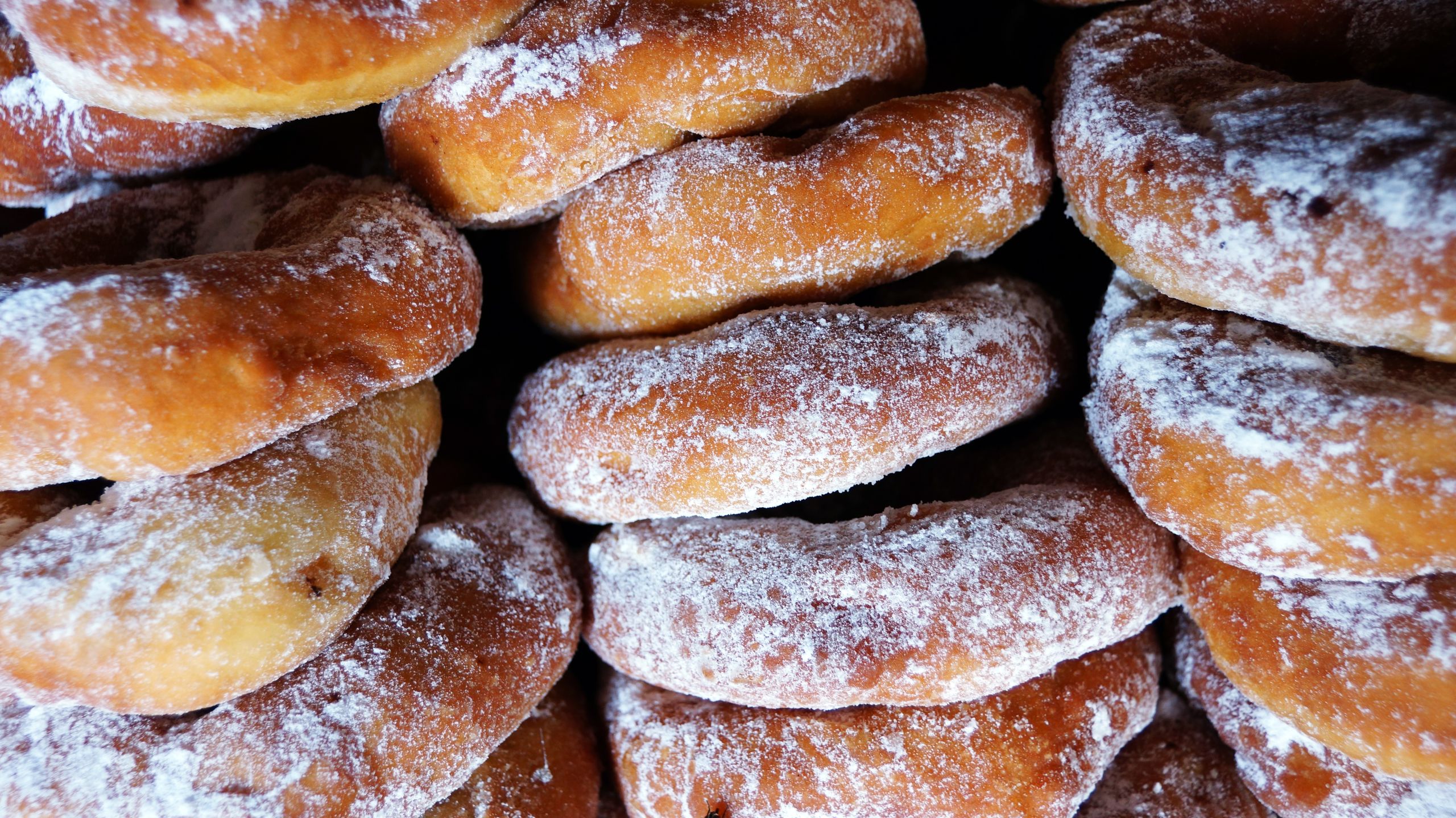 Close-up of traditional Malaysian iced doughnuts stacked freshly baked in Kota Kinabalu.