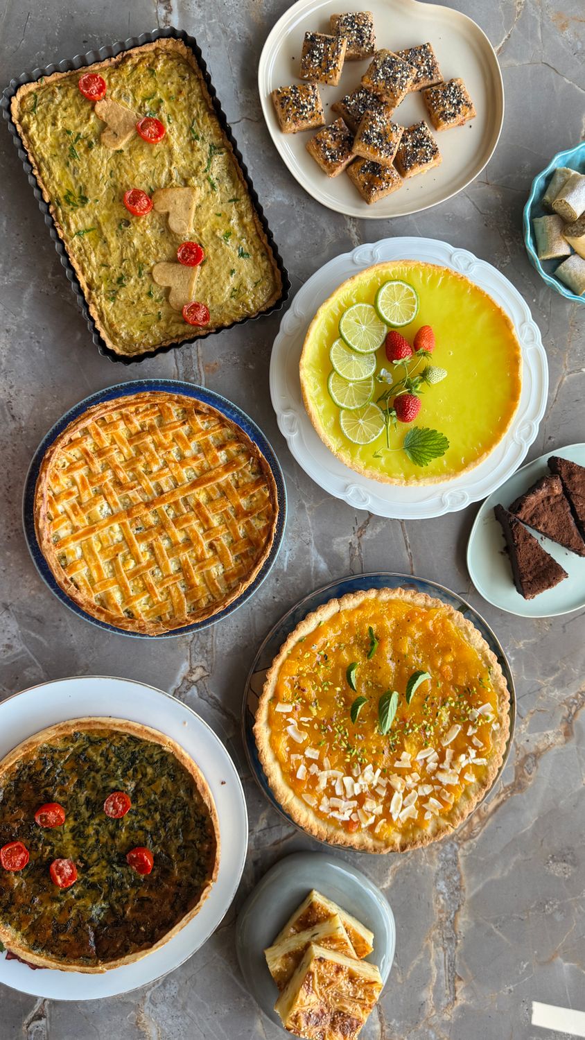 Move Over, Croissants: Savory Tarts Are Giving America’s Bakeries a Delicious Lunch Upgrade 2 Colorful assortment of tarts and pastries on a marble surface, perfect for culinary inspiration.