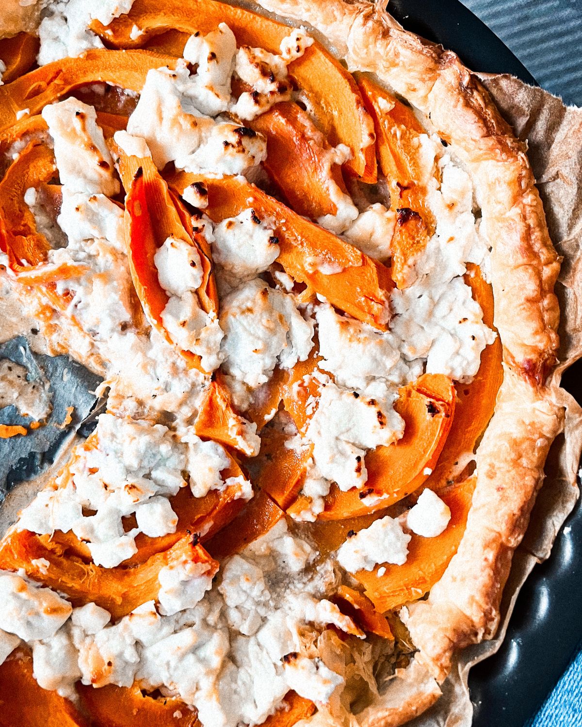 Delicious butternut squash tart topped with creamy ricotta cheese, perfect for fall.