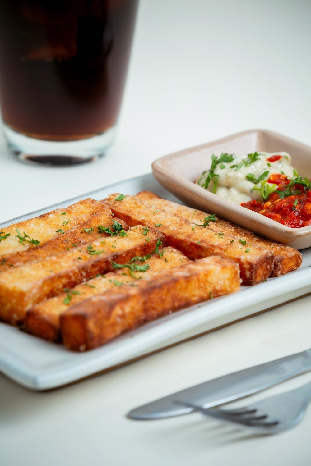Move Over, Potato Fries: These Crispy Polenta Sticks Bring the Crunch and the Cheese 1 Delicious crispy tofu sticks served with salsa and creamy dip, perfect for a snack.